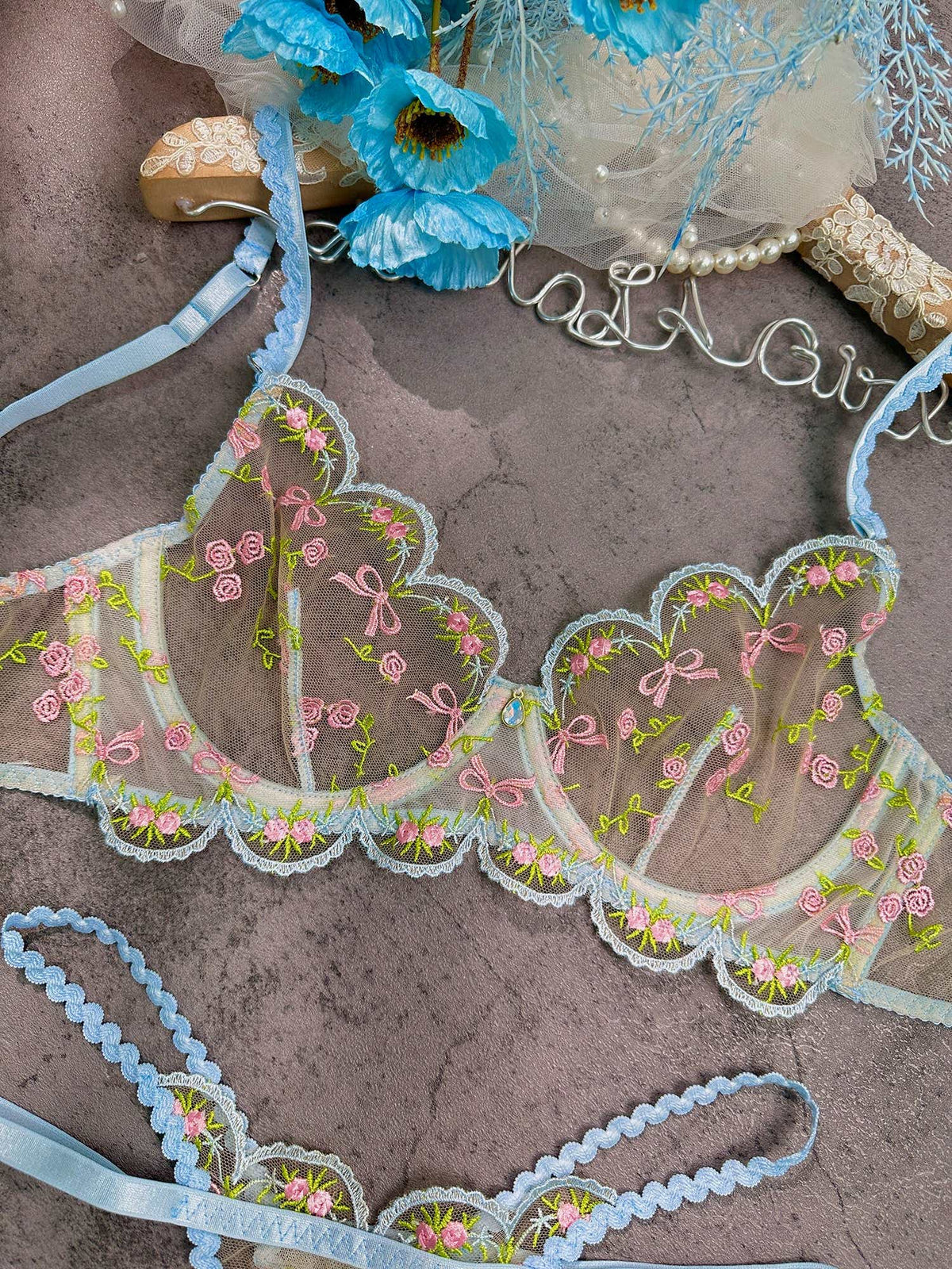 Stylish arrangement of the Elegant 2-Piece Light Blue Lace Lingerie Set, highlighting the intricate details and elegance of light blue lace lingerie.