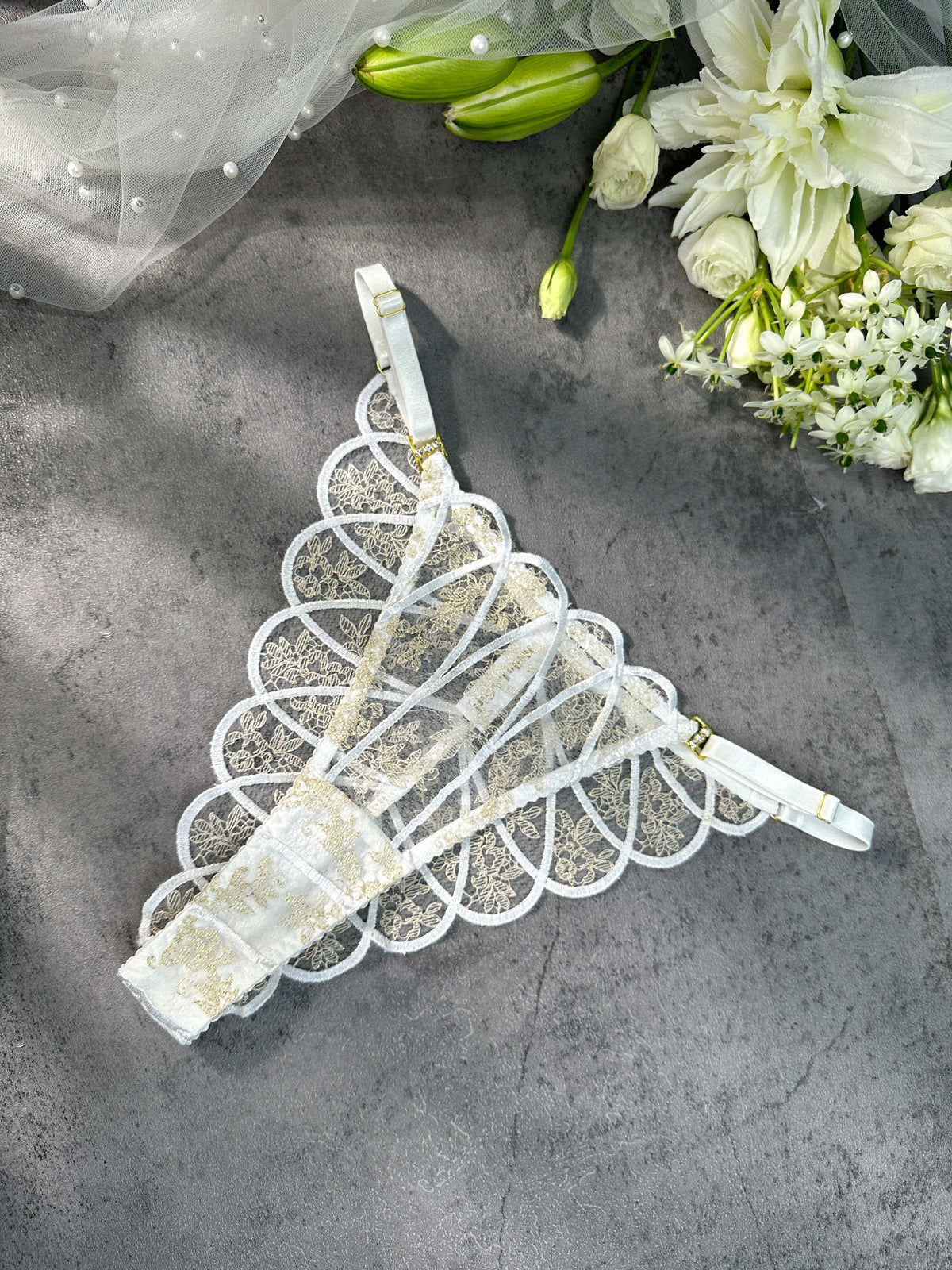 Captivating view of the Heavenly Glow Radiance bridal lingerie set that exudes luxury with its satin fabric and gold embroidery.