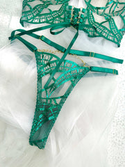 Flat lay of the Luxe Green Metallic Lingerie Set featuring adjustable straps and gold chain accents, illustrating the luxurious aesthetic and seductive style of this metallic lingerie set.
