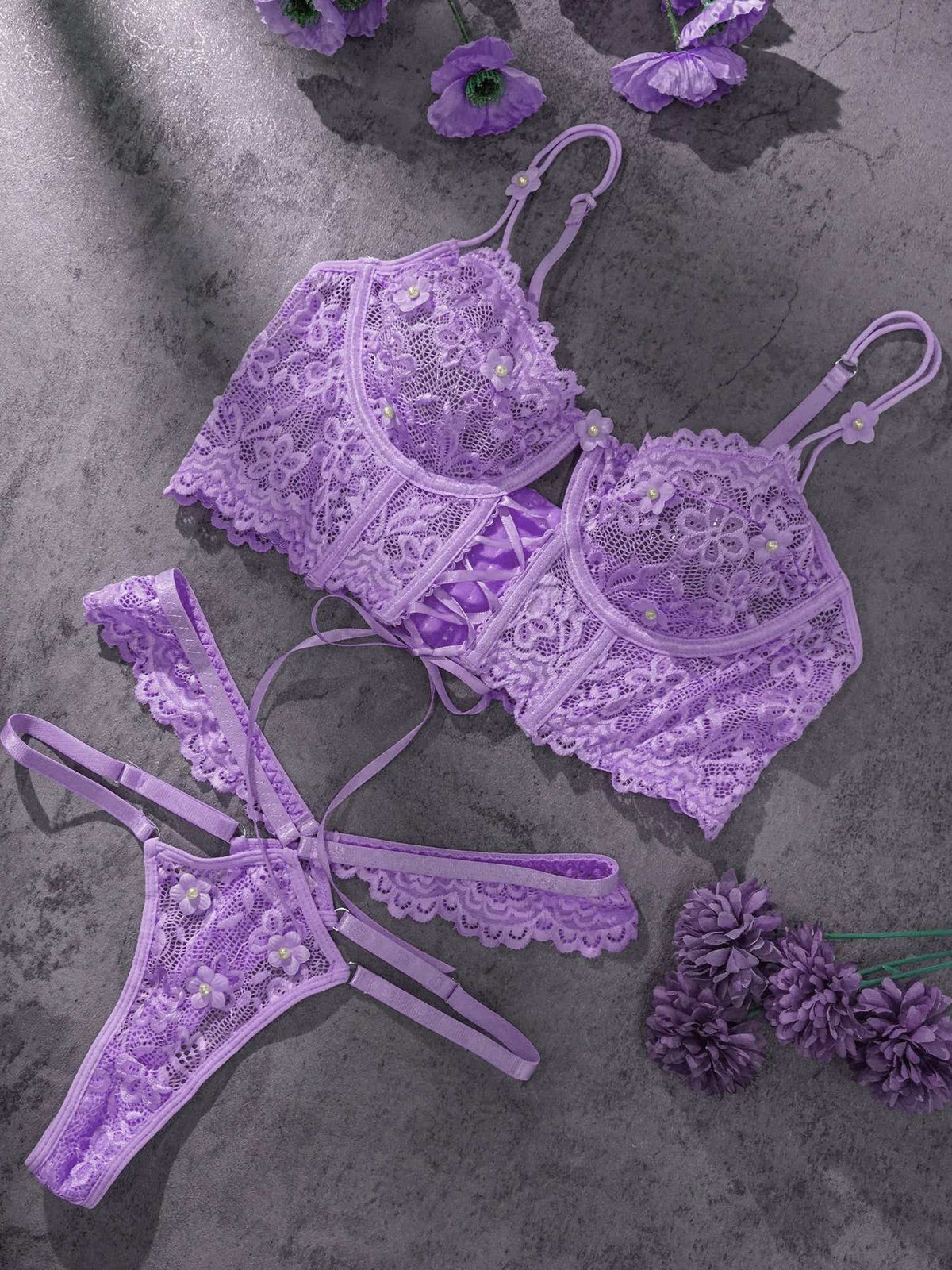Stylish flat lay of Lavender Lace Bralette and Thong Set emphasizing the delicate lace with floral embroidery and luxurious pearl accents on the bralette and thong.